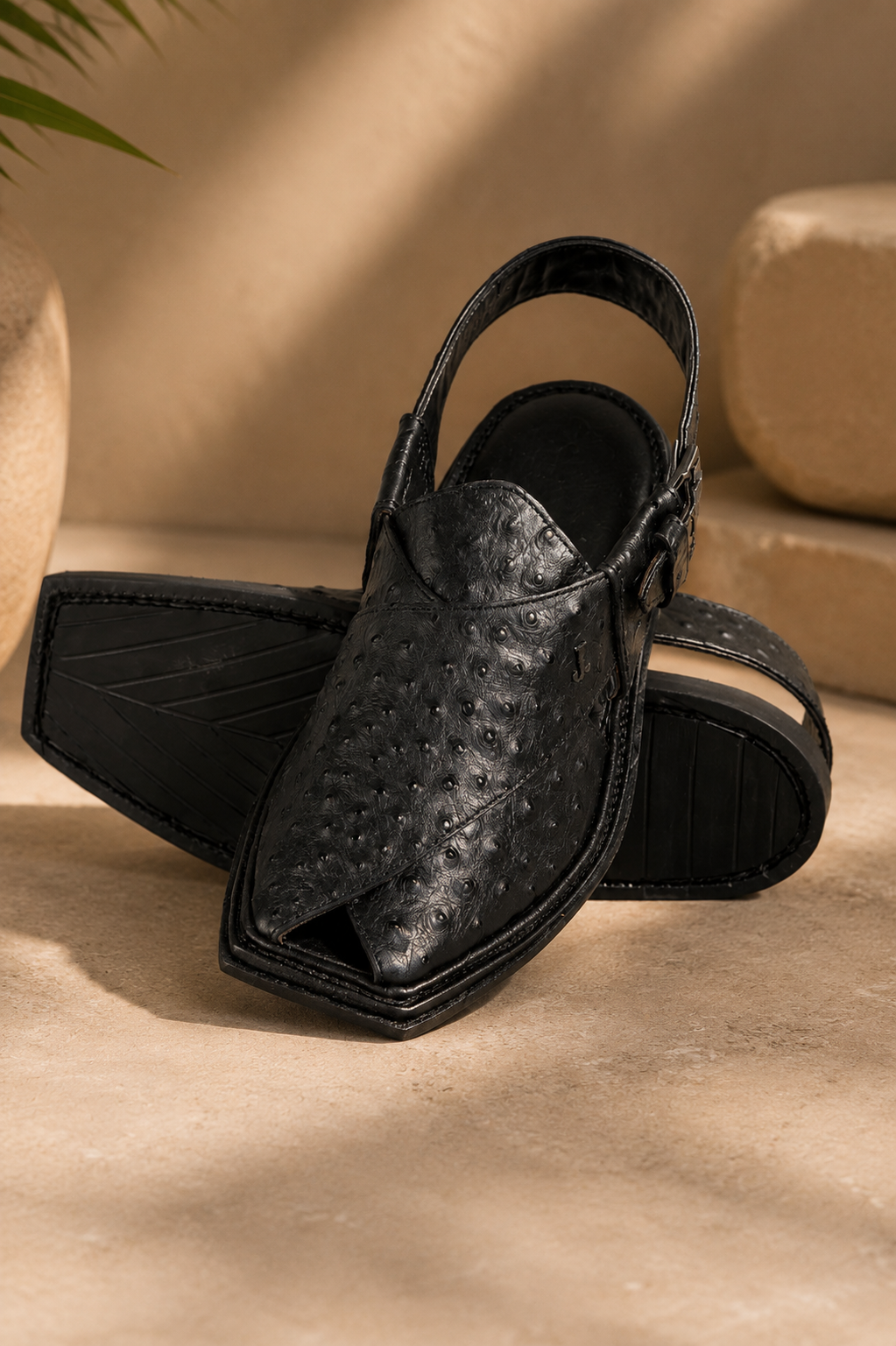 Men's black leather Peshawari chappal with textured traditional Pakistani design
